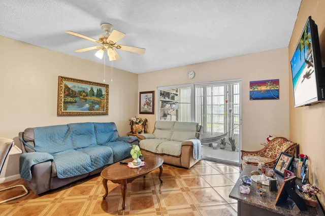 a living room with furniture a couch and paintings on the wall