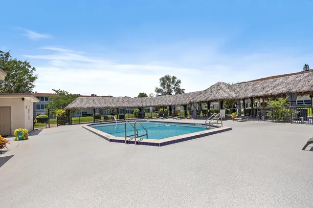 a view of a swimming pool with a yard