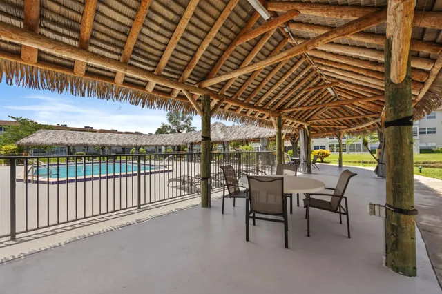 a view of a porch with furniture and a backyard