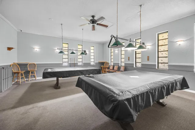 a spacious bedroom with a bed a table and chairs