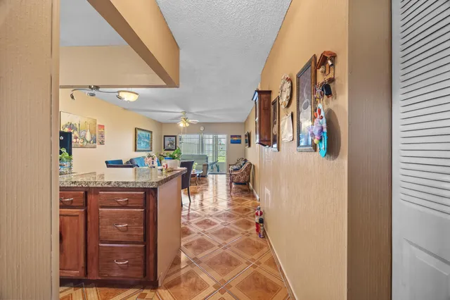 a view of living room with granite countertop furniture and a flat screen tv