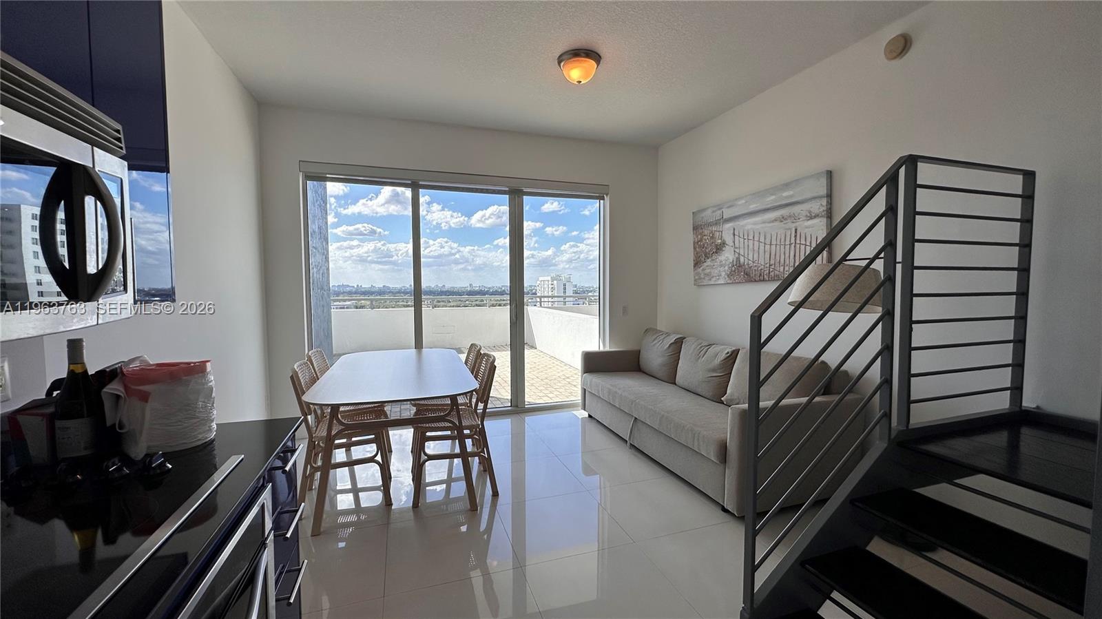 60 Southwest 13th Street, Unit 1115 Miami, FL 33130 - Photo 3 of 11 a living room with furniture and a flat screen tv
