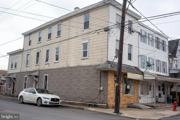 a front view of a house with parking area