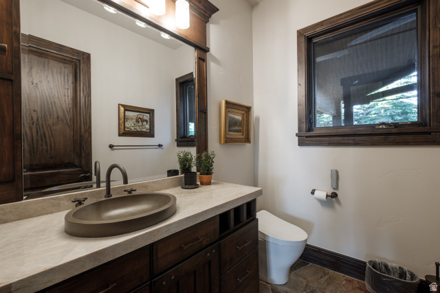 9156 Forest Road, Unit 24 Heber City, UT 84036 - Photo 22 of 42 Bathroom featuring a dark wood vanity with a light-toned countertop, an oval vessel sink, and a dark bronze faucet