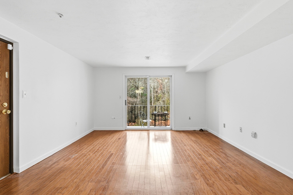 356 Neponset Street, Unit E Canton, MA 02021 - Photo 18 of 22 an empty room with wooden floor and windows