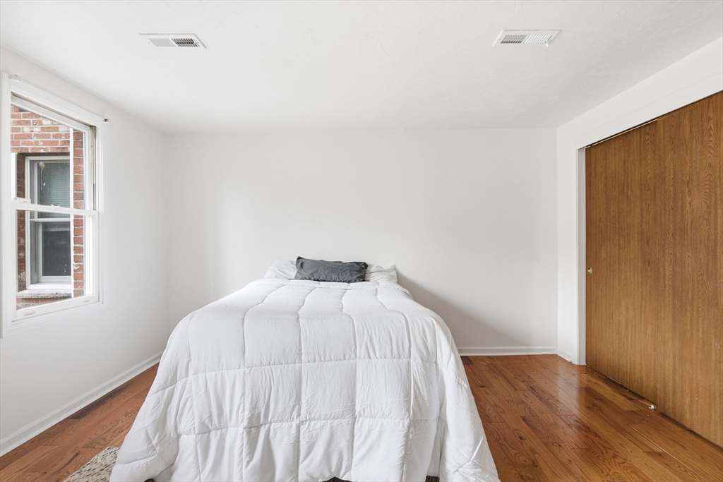356 Neponset Street, Unit E Canton, MA 02021 - Photo 2 of 22 a bedroom with a bed and wooden floor