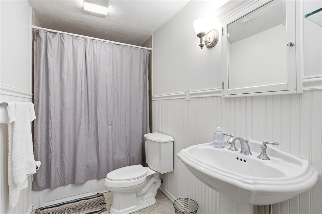 356 Neponset Street, Unit E Canton, MA 02021 - Photo 6 of 22 a bathroom with a sink a toilet and a mirror