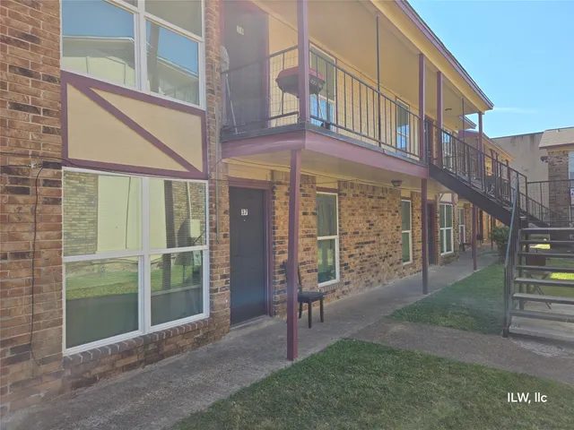 a view of a building with a yard from a corridor