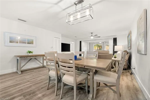 a view of a dining room with furniture and wooden floor