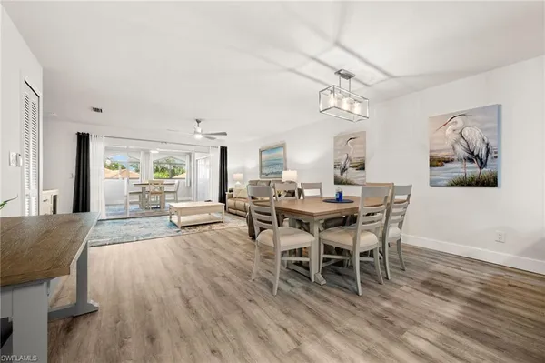 a view of a dining room with furniture and wooden floor
