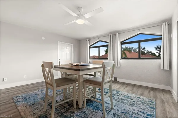 a view of a dining room with furniture and a window