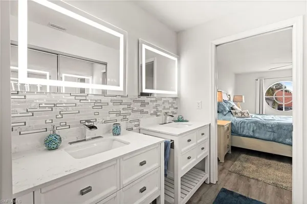 a spacious bathroom with a double vanity sink and a window