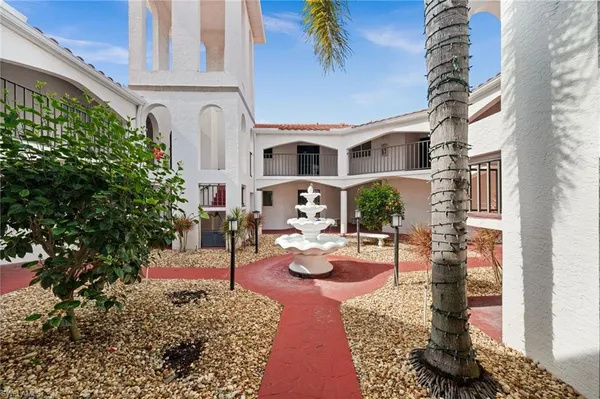 a front view of a house with outdoor seating