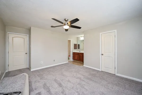 a view of an empty room and a ceiling fan