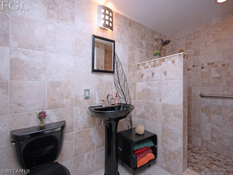 1458 Collins Road Fort Myers, FL 33919 - Photo 8 of 19 a bathroom with a sink and a mirror