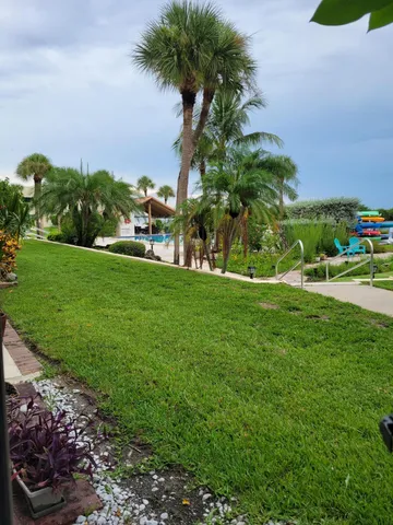 a backyard of a house with table and chairs