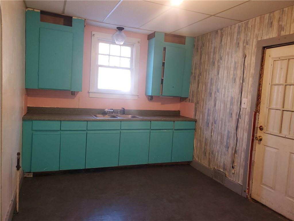 435 1/2 Reesman Drive, Unit 2 Kittanning, PA 16201 - Photo 11 of 14 a room with green cabinets and a window