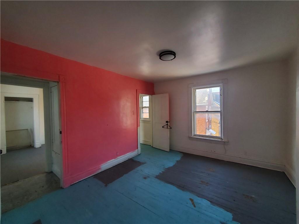 435 1/2 Reesman Drive, Unit 2 Kittanning, PA 16201 - Photo 6 of 14 an empty room with wooden floor and windows