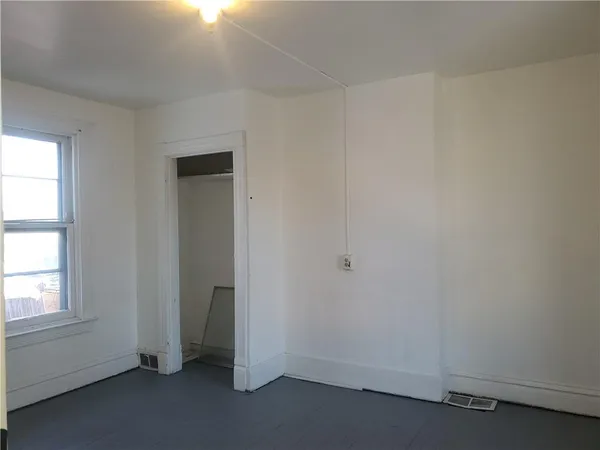 an empty room with a empty space and window