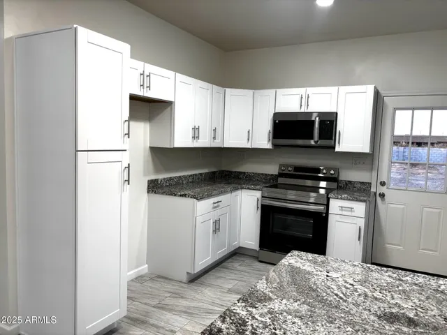 a kitchen with a refrigerator stove and microwave