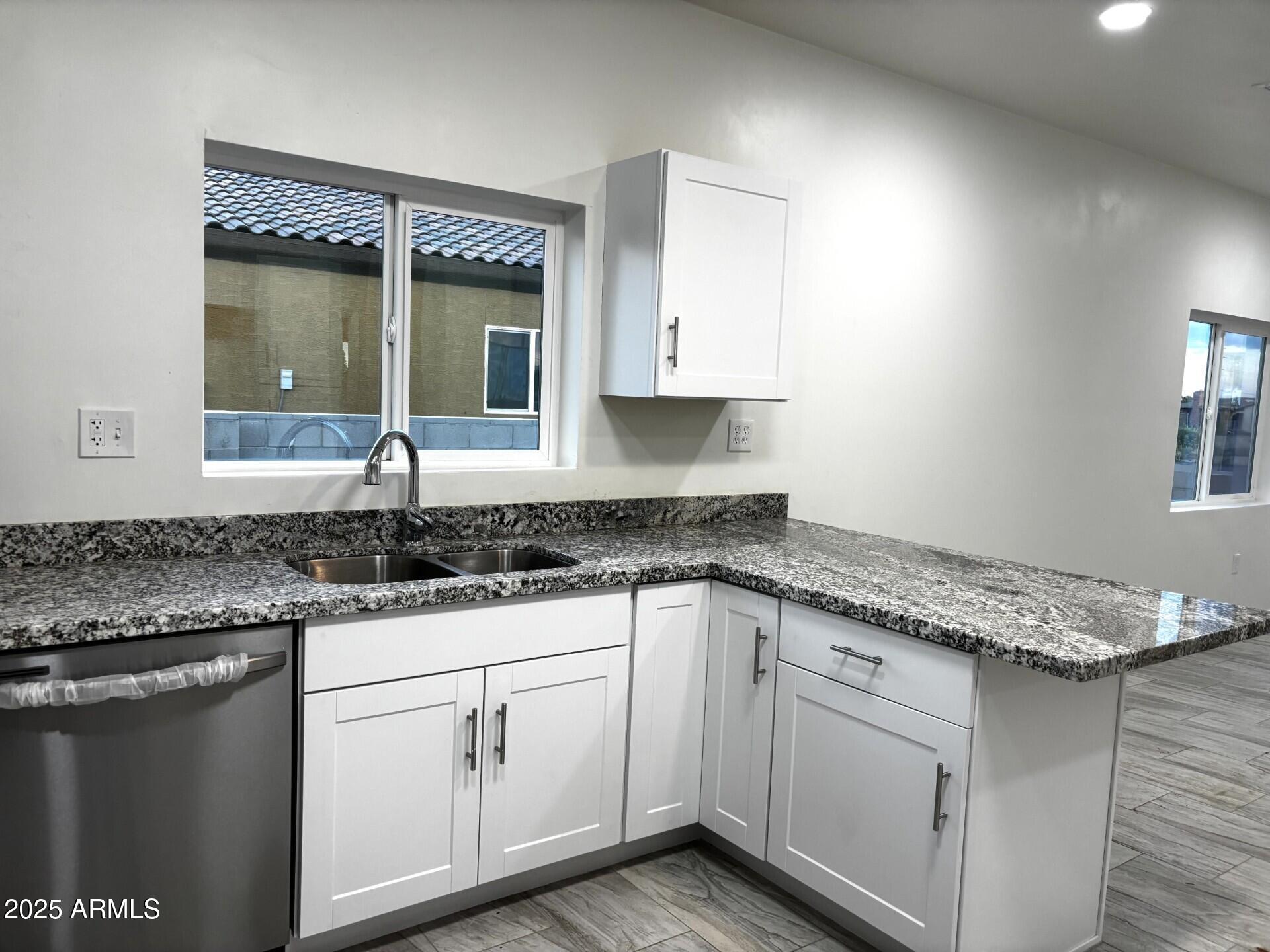 486 Anderson Avenue Douglas, AZ 85607 - Photo 4 of 16 a kitchen with granite countertop white cabinets and white appliances