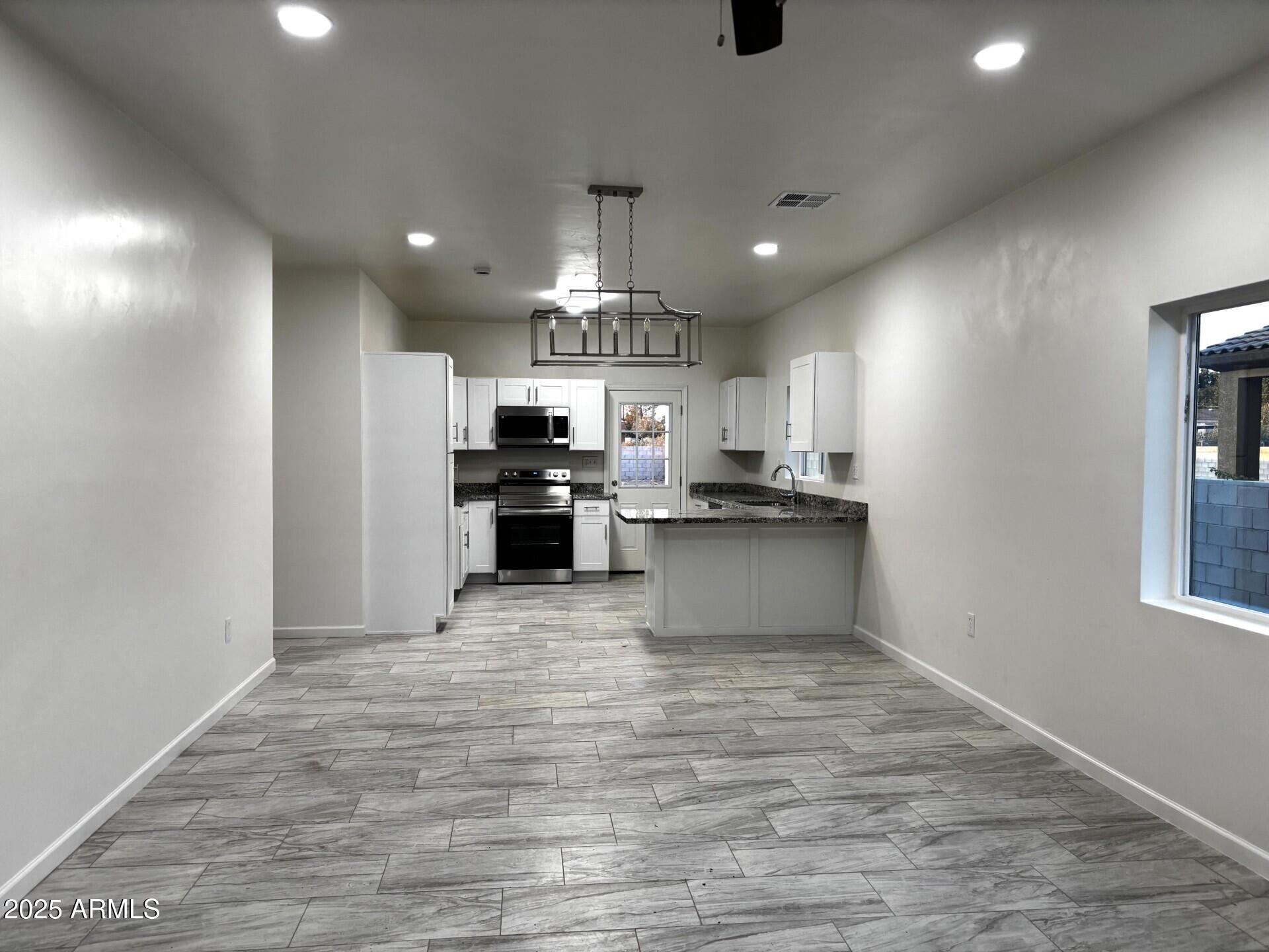 486 Anderson Avenue Douglas, AZ 85607 - Photo 7 of 16 a large kitchen with kitchen island a sink stainless steel appliances and cabinets