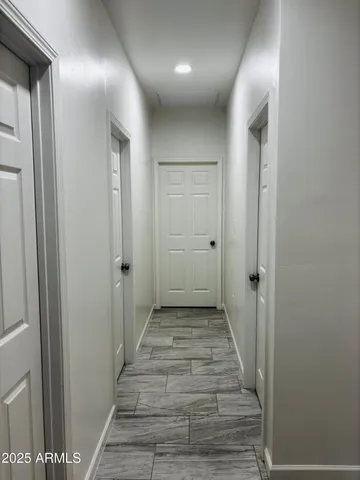 a view of a hallway with wooden floor