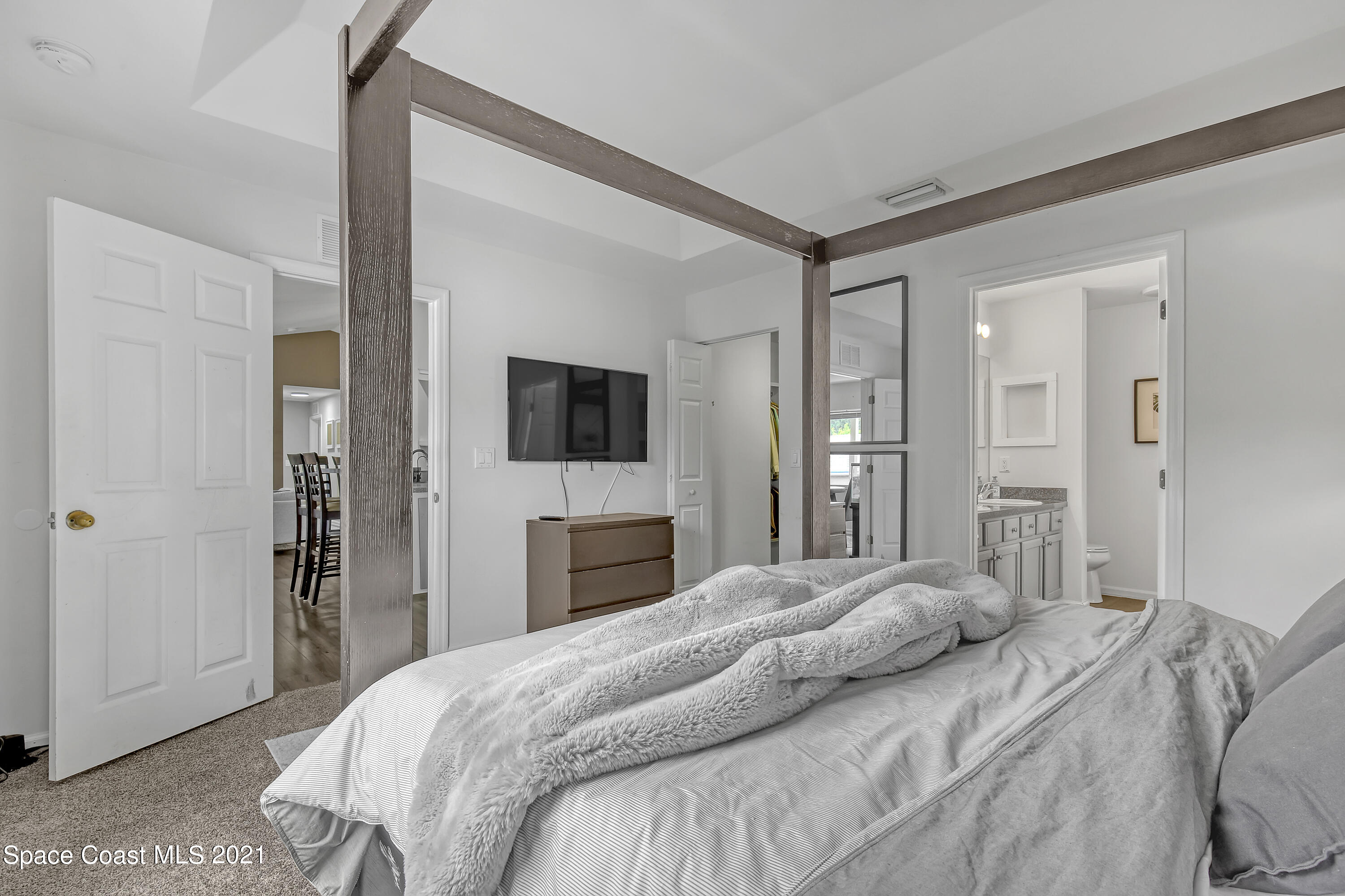 1277 Harlingen Road Southwest Palm Bay, FL 32908 - Photo 16 of 32 a bedroom with a bed and a flat screen tv