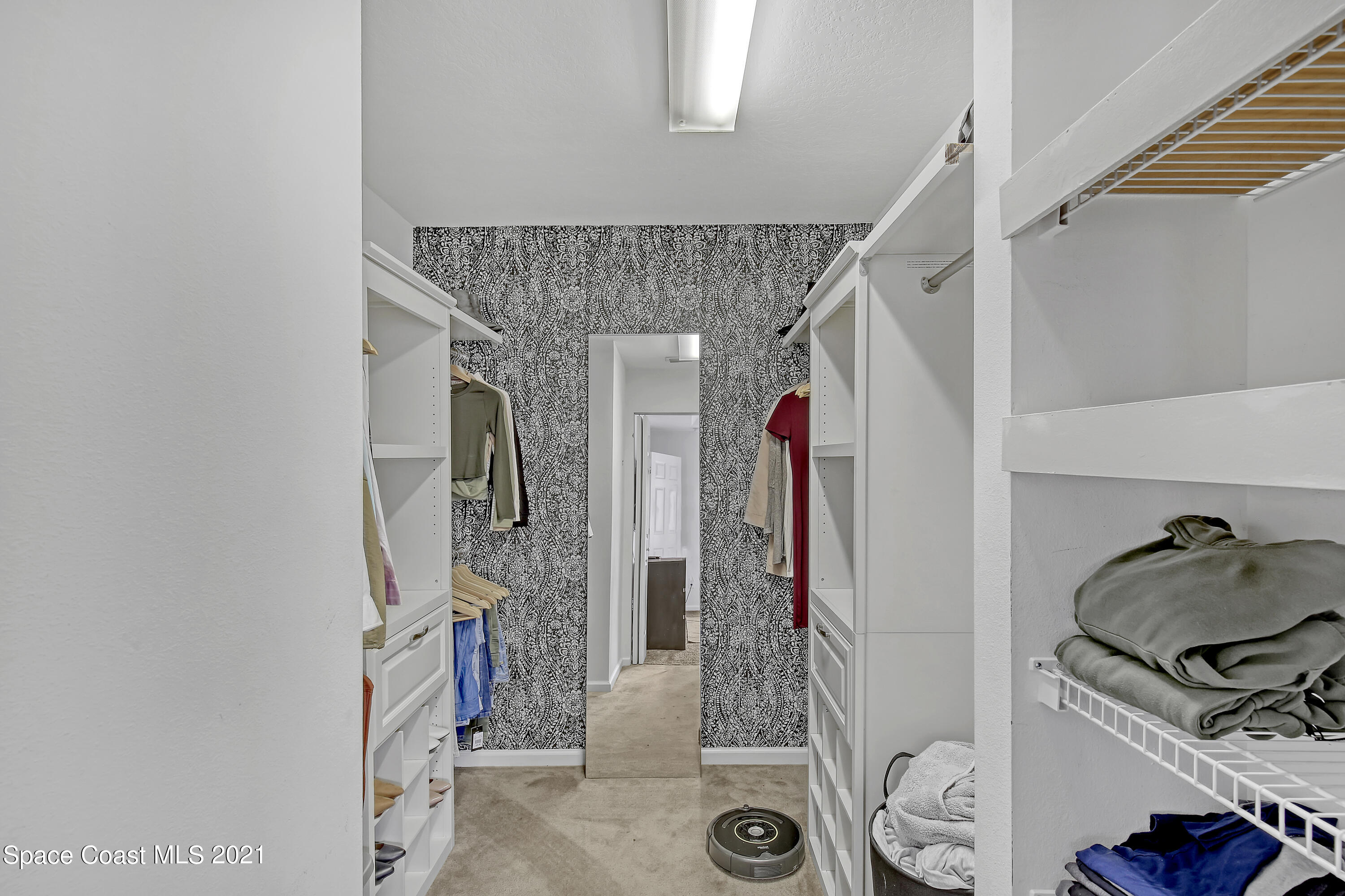 1277 Harlingen Road Southwest Palm Bay, FL 32908 - Photo 17 of 32 a view of walk in closet with clothes and shoes