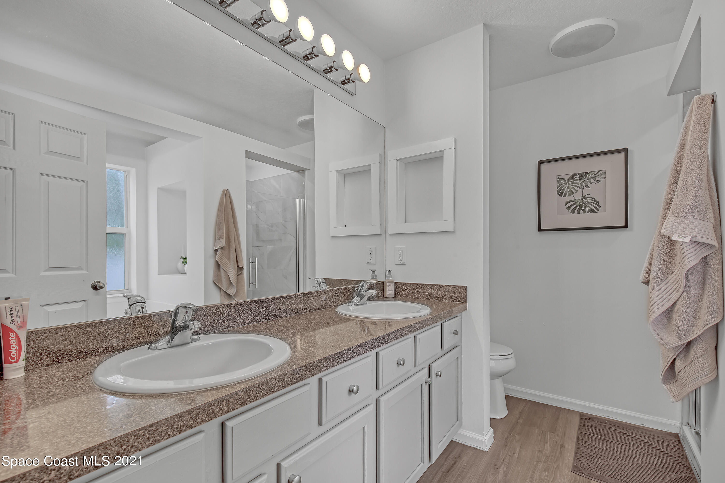 1277 Harlingen Road Southwest Palm Bay, FL 32908 - Photo 18 of 32 a bathroom with a granite countertop sink a mirror and a