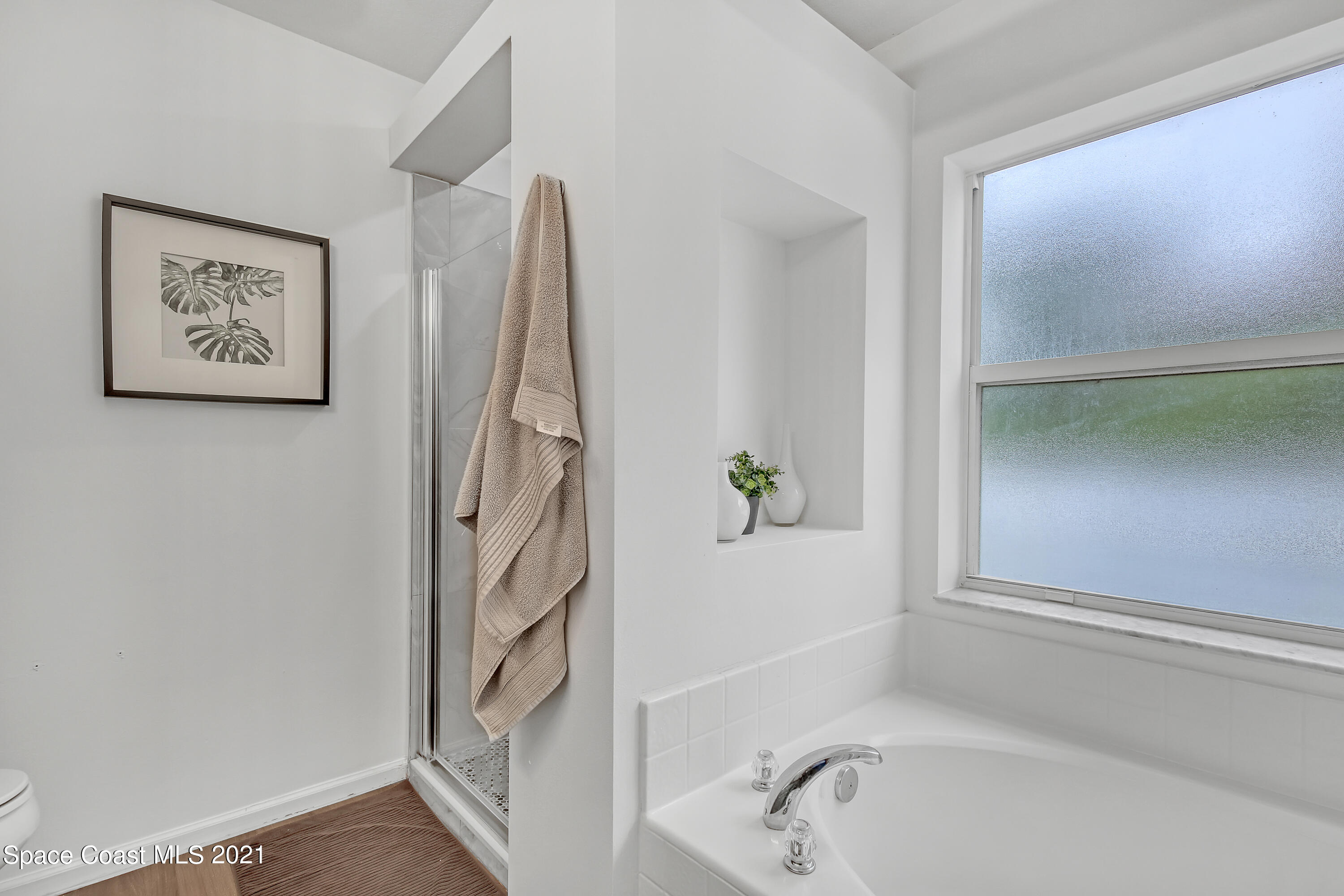 1277 Harlingen Road Southwest Palm Bay, FL 32908 - Photo 20 of 32 a bathroom with a bathtub and a shower