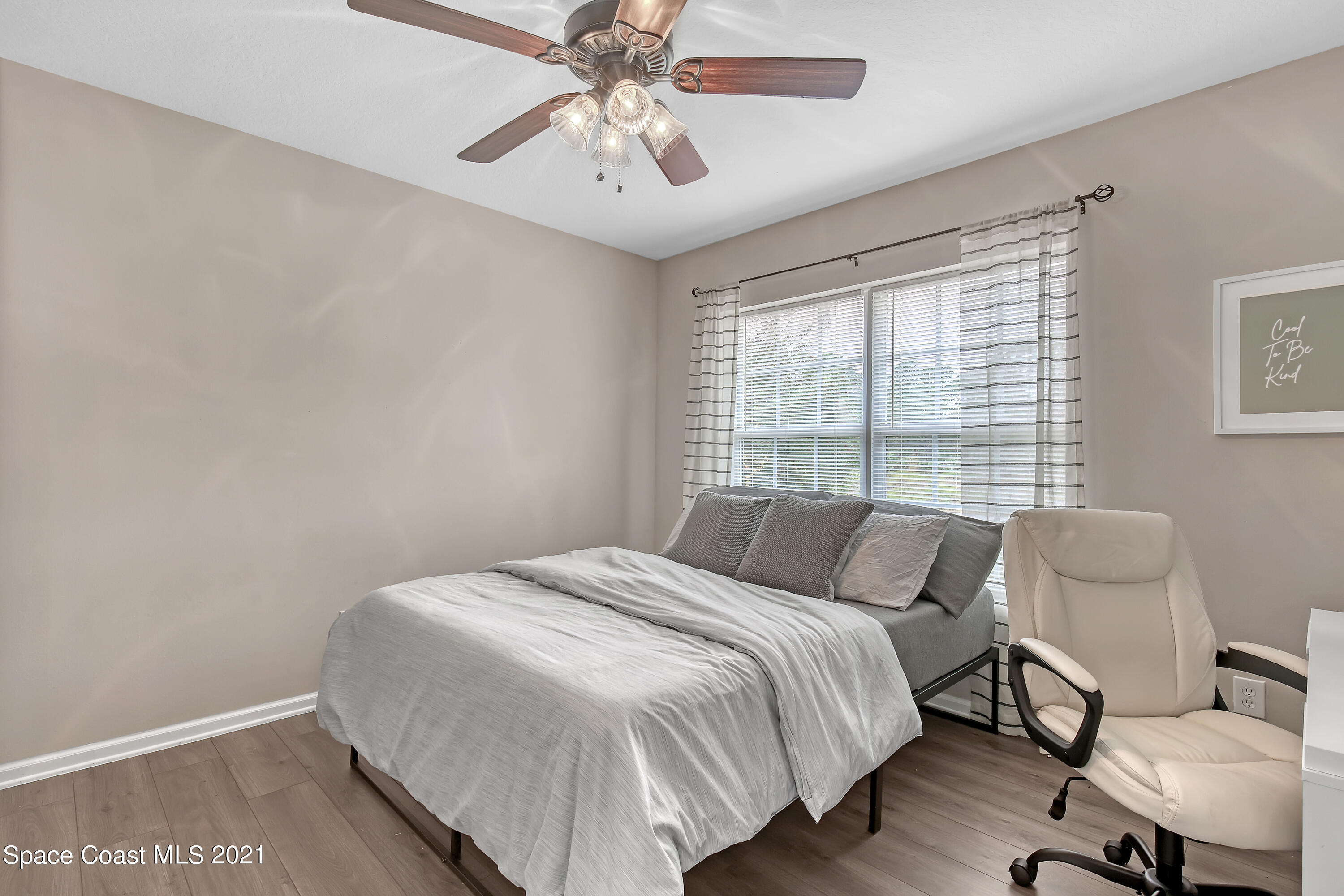 1277 Harlingen Road Southwest Palm Bay, FL 32908 - Photo 21 of 32 a bedroom with a bed and a chandelier