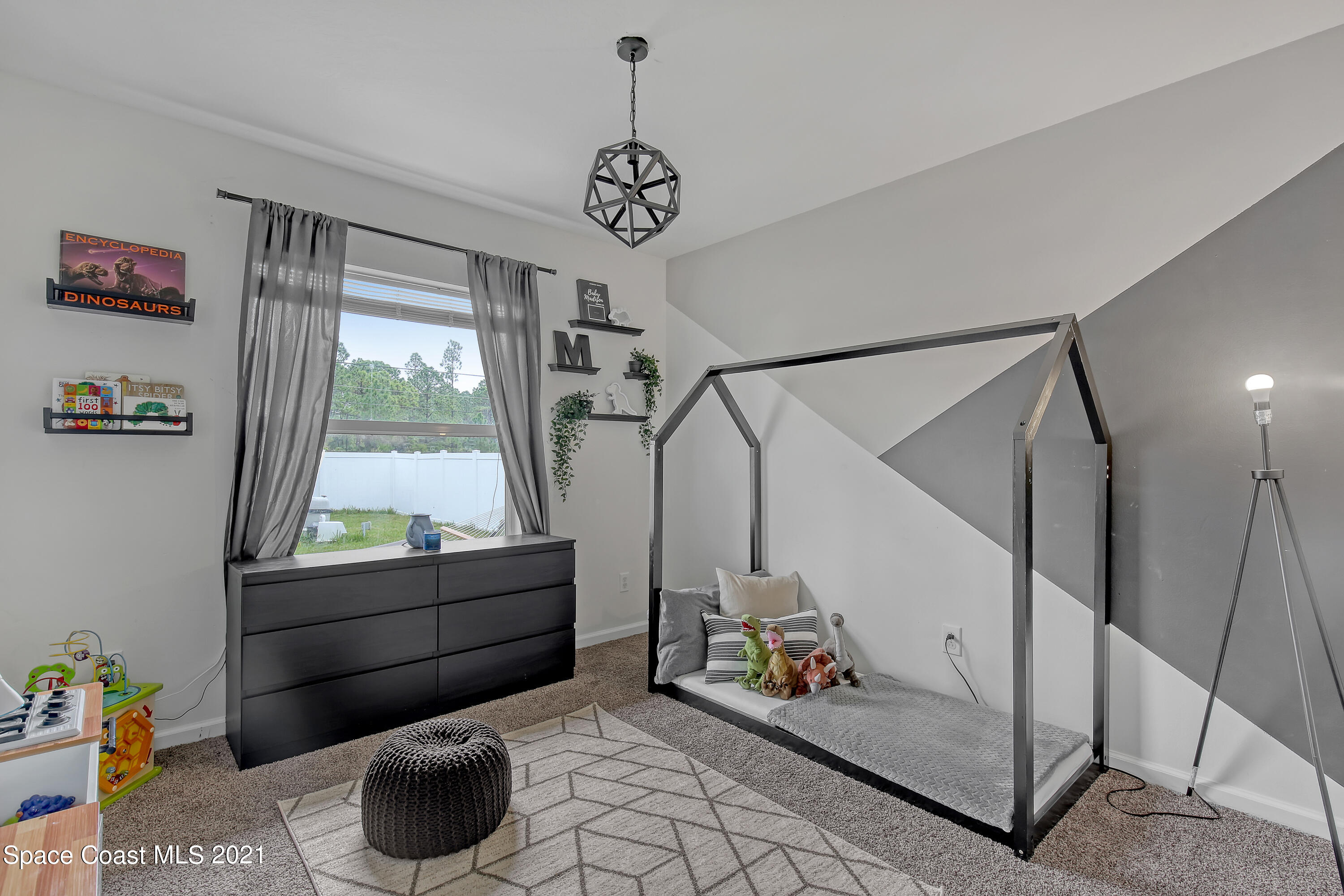 1277 Harlingen Road Southwest Palm Bay, FL 32908 - Photo 22 of 32 a living room with furniture and a window