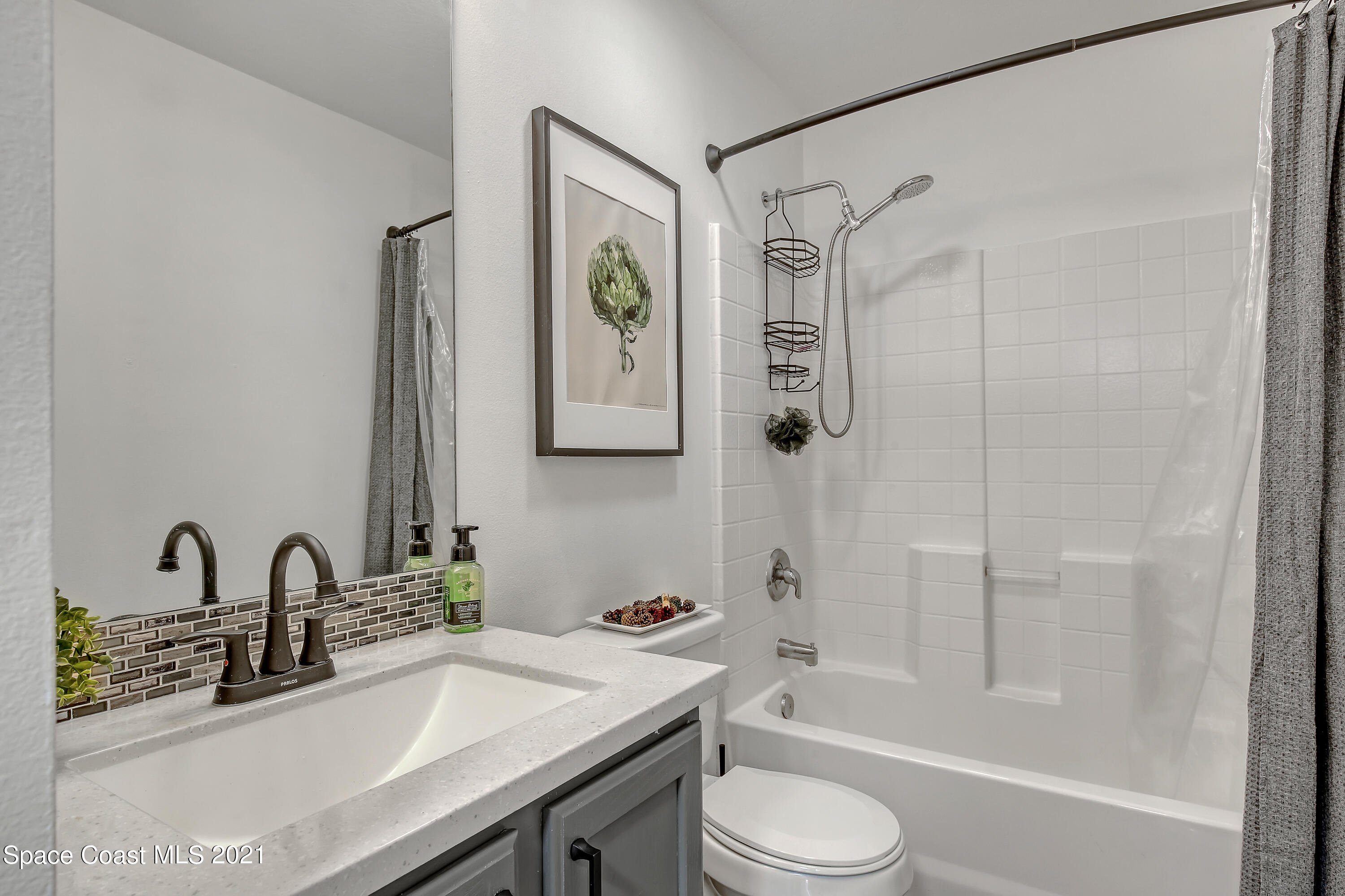 1277 Harlingen Road Southwest Palm Bay, FL 32908 - Photo 24 of 32 a bathroom with a sink toilet and shower