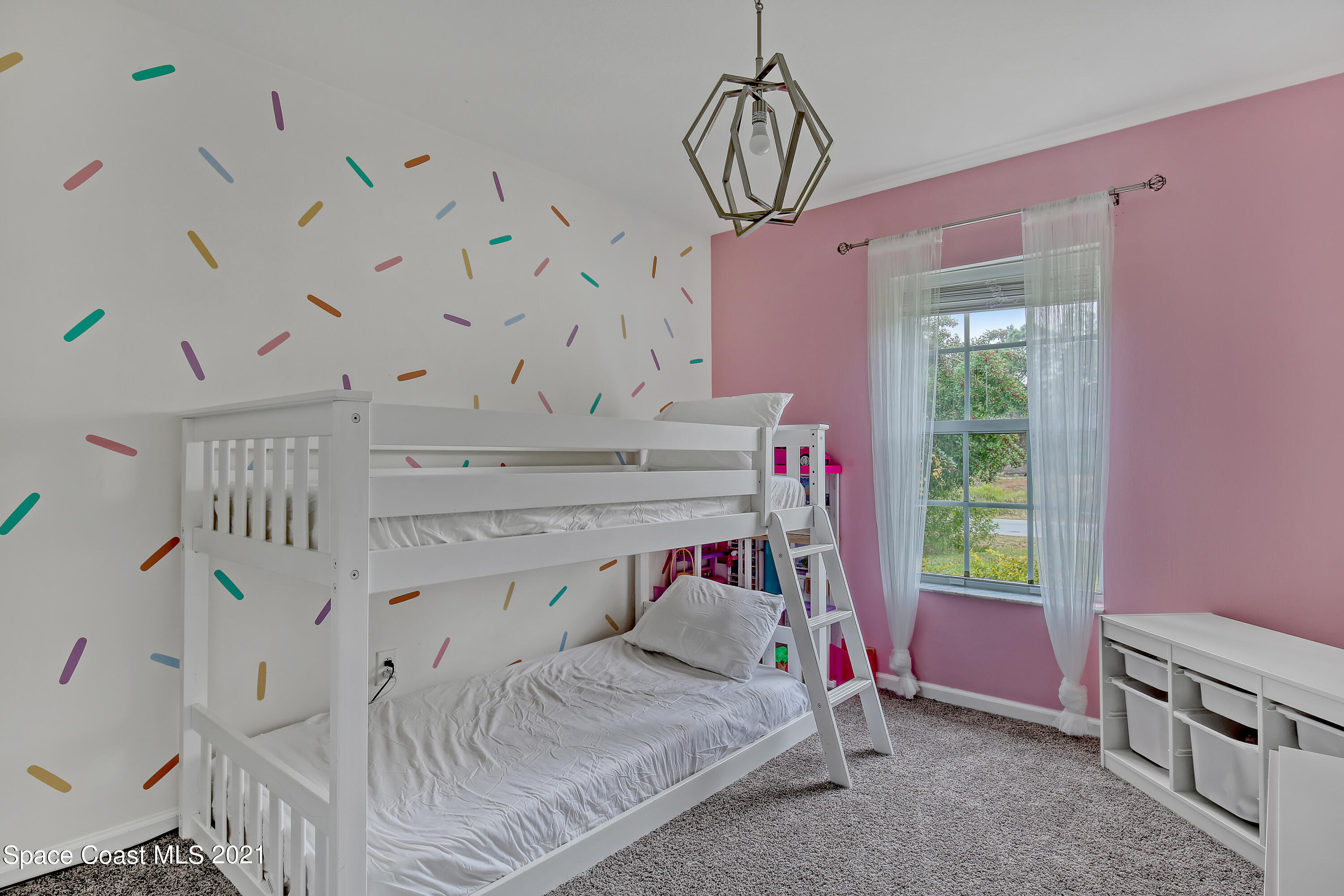 1277 Harlingen Road Southwest Palm Bay, FL 32908 - Photo 25 of 32 a bed room with a bed and a chandelier