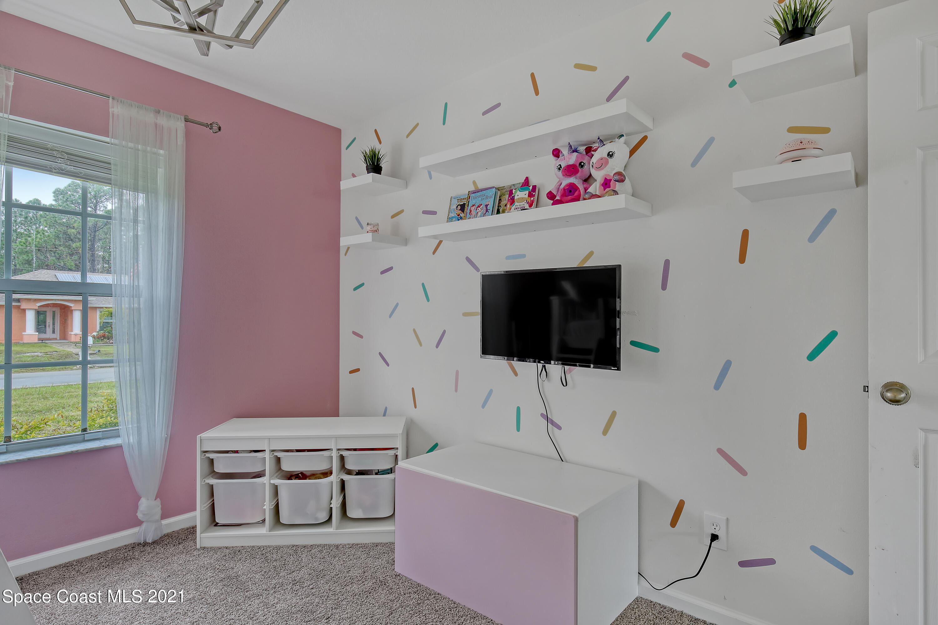 1277 Harlingen Road Southwest Palm Bay, FL 32908 - Photo 26 of 32 a living room with furniture and a flat screen tv