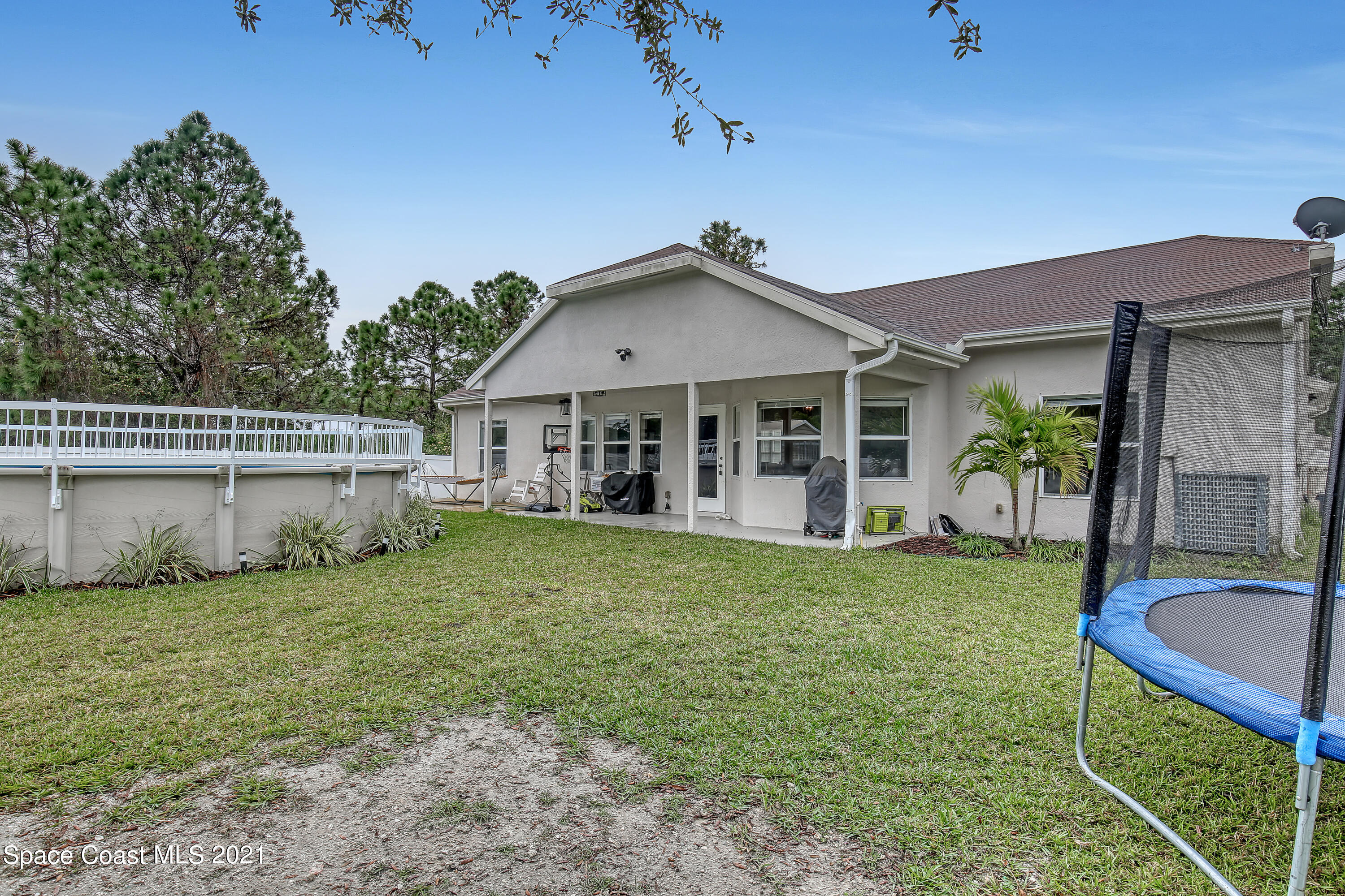 1277 Harlingen Road Southwest Palm Bay, FL 32908 - Photo 29 of 32 a view of a house with a yard potted plants