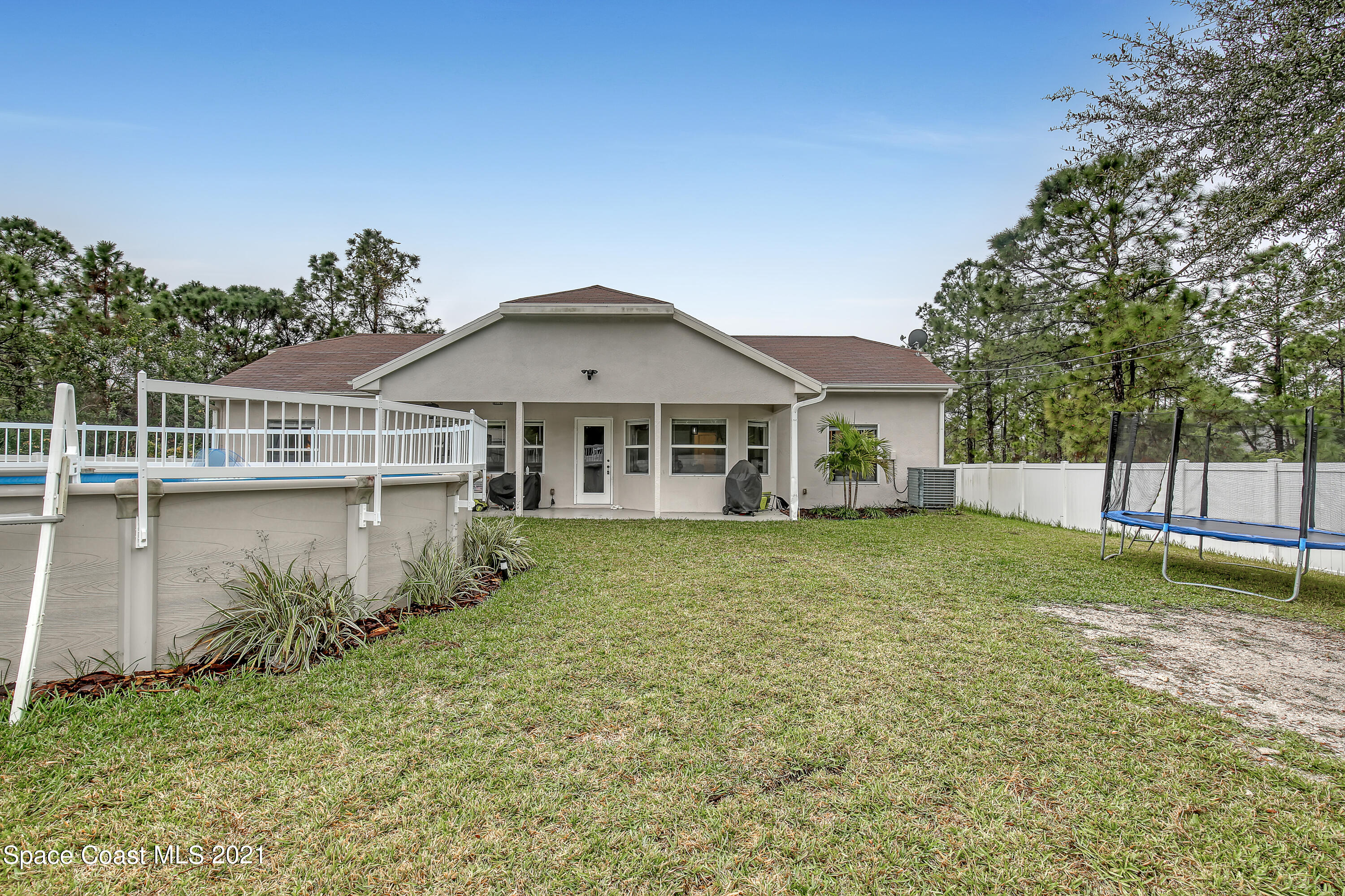 1277 Harlingen Road Southwest Palm Bay, FL 32908 - Photo 31 of 32 a view of a house with a yard and a garden
