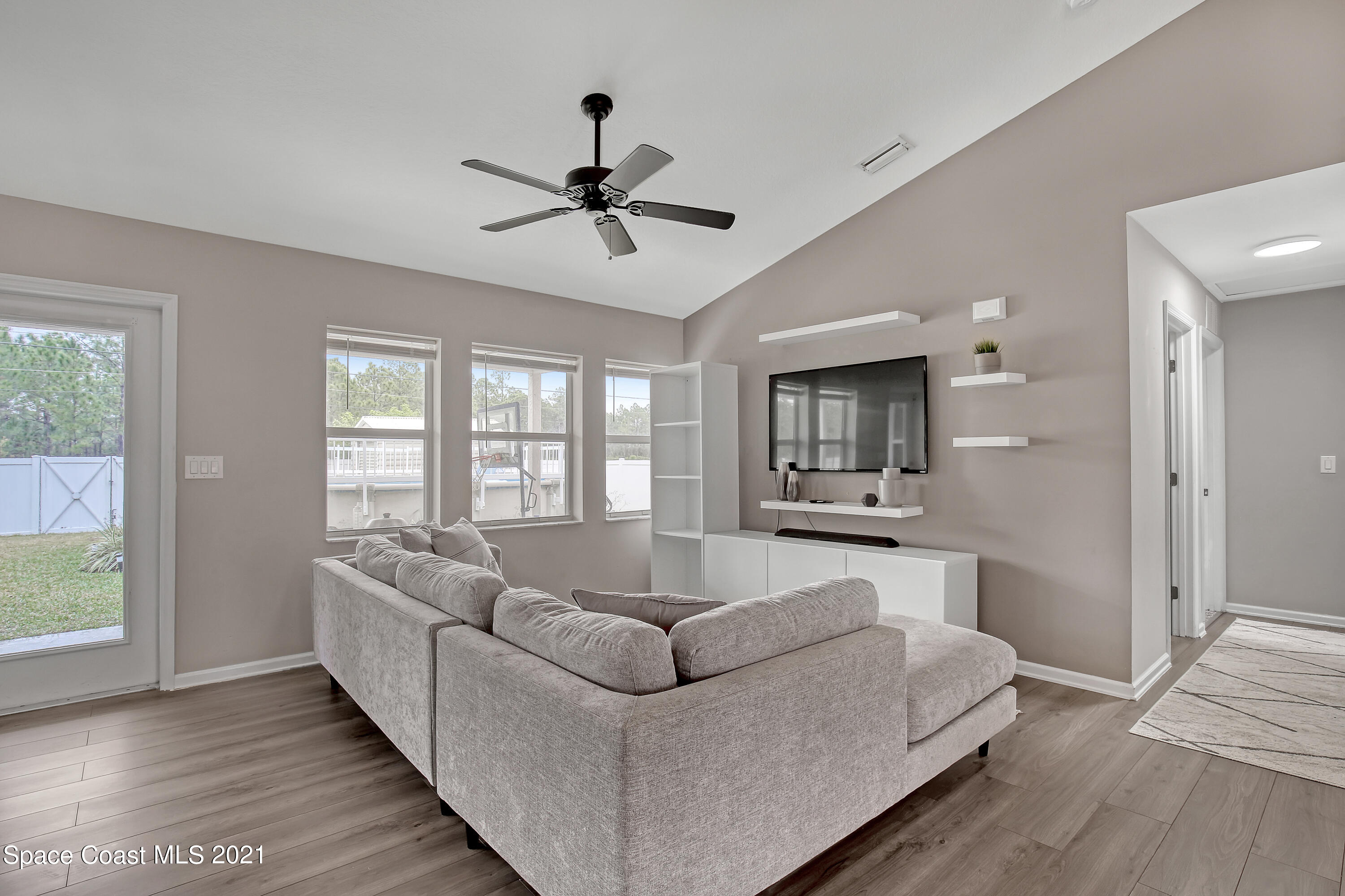 1277 Harlingen Road Southwest Palm Bay, FL 32908 - Photo 4 of 32 a living room with furniture and a large window