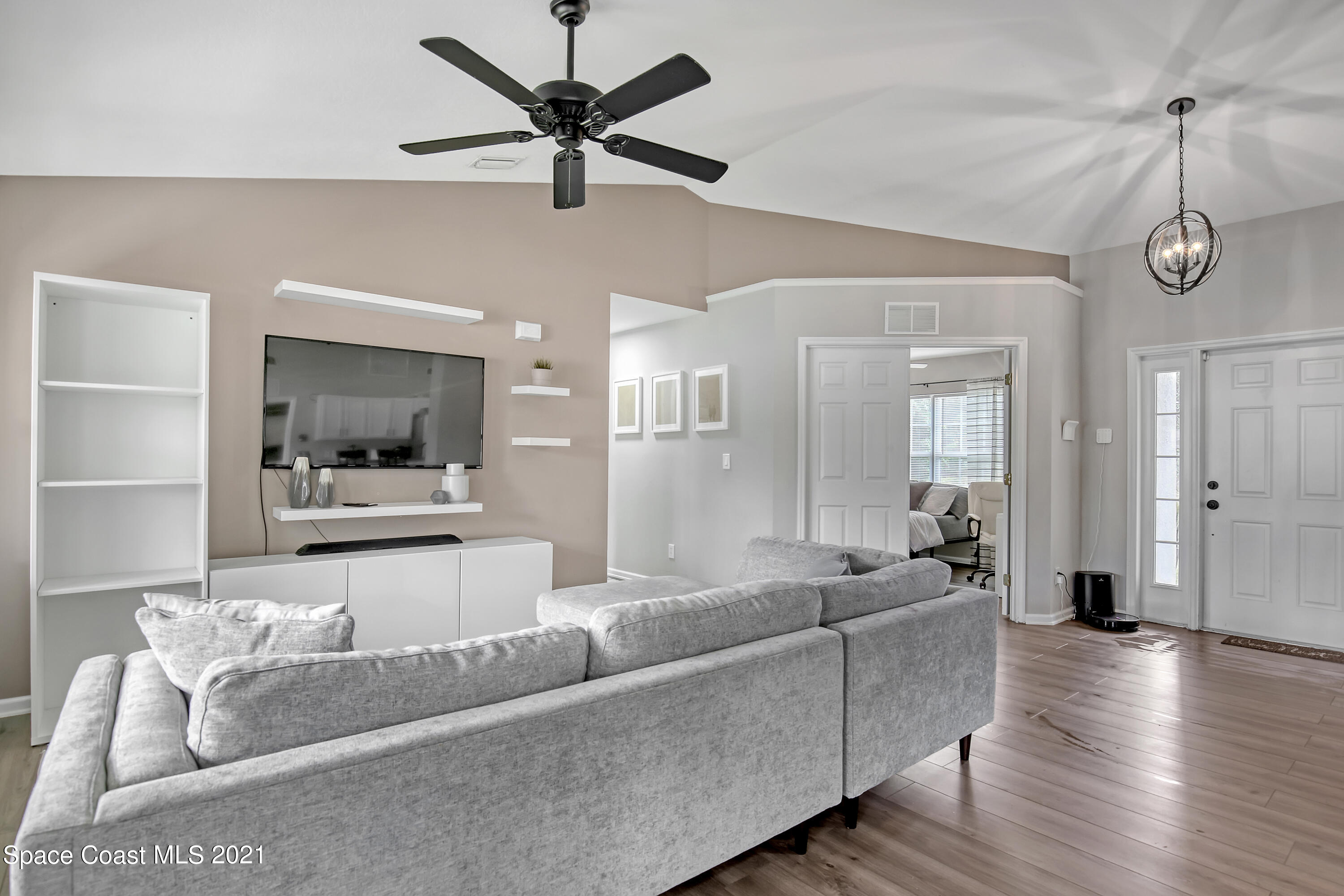 1277 Harlingen Road Southwest Palm Bay, FL 32908 - Photo 6 of 32 a living room with furniture and a wooden floor