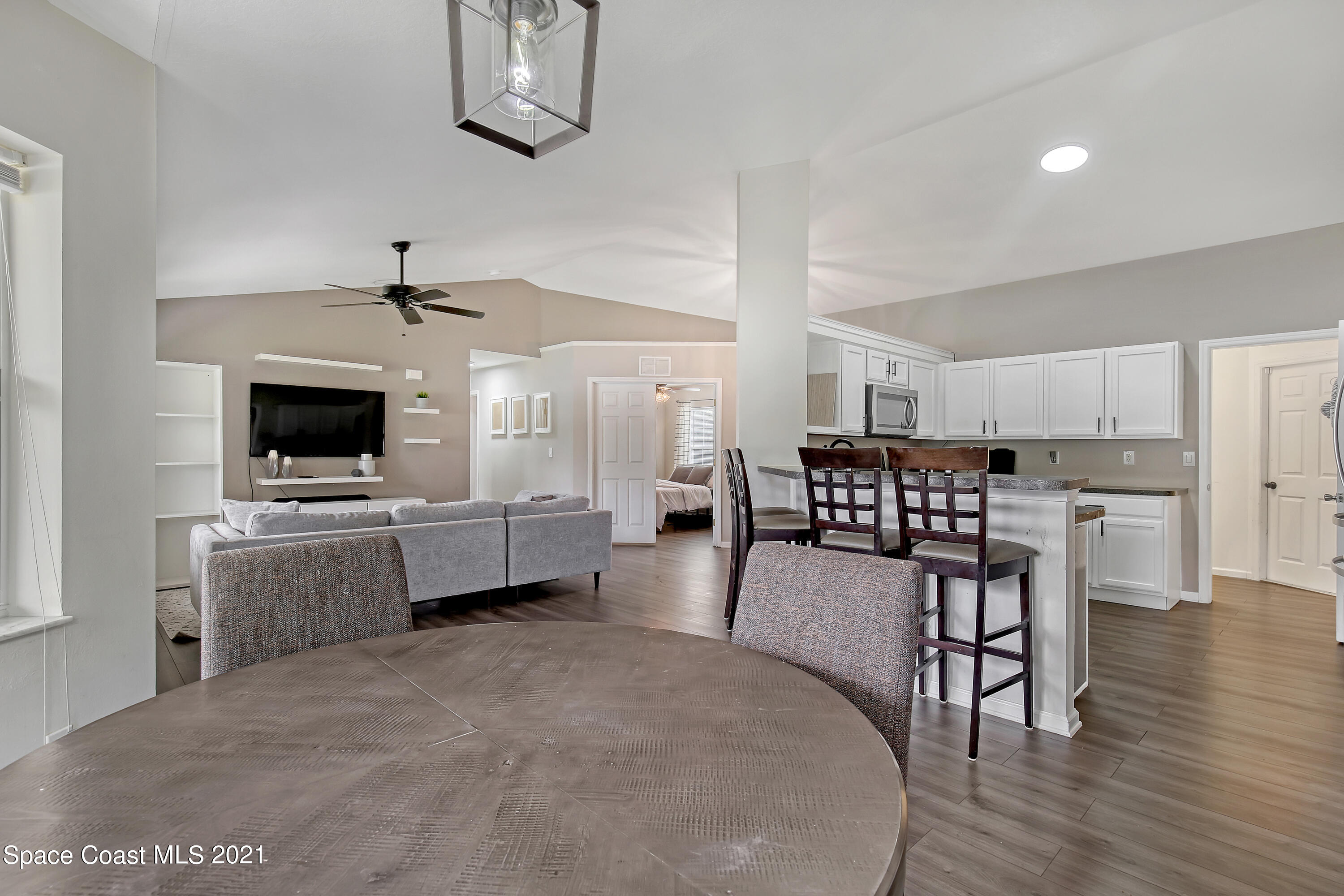 1277 Harlingen Road Southwest Palm Bay, FL 32908 - Photo 9 of 32 a large kitchen with a table and chairs
