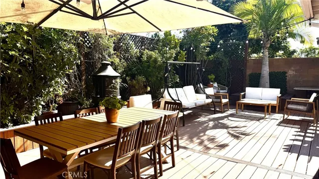 a view of a patio with a table and chairs under an umbrella