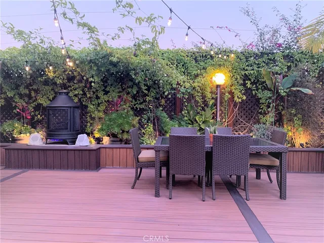 a backyard of a house with table and chairs