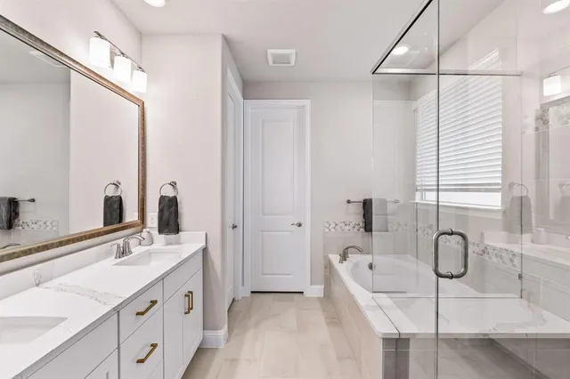 a bathroom with a tub sink and mirror