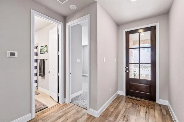 a view of a hallway view with wooden floor and staircase