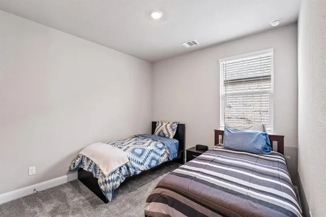 a bedroom with two beds and a window