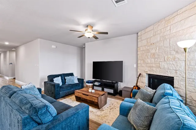 a living room with furniture and a fireplace