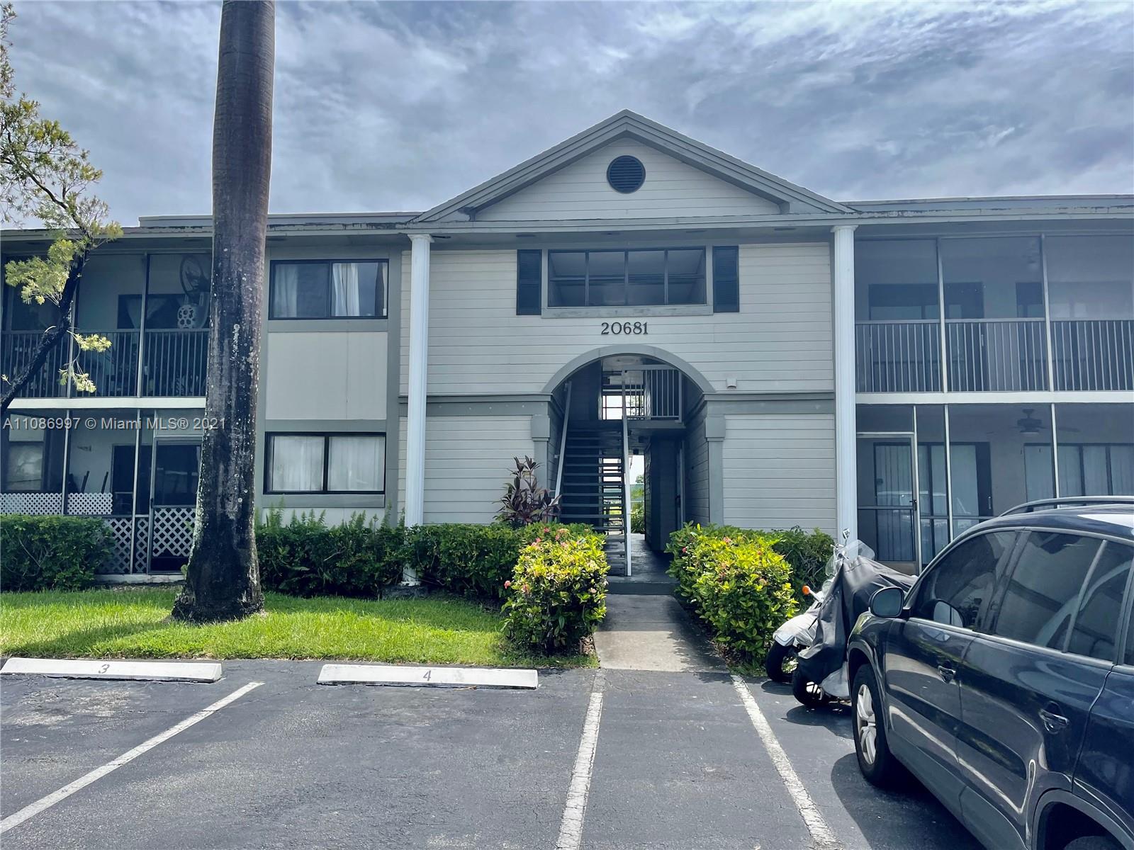 20681 Northeast 4th Place, Unit 101 Miami, FL 33179 - Photo 1 of 5 a front view of a house with garden