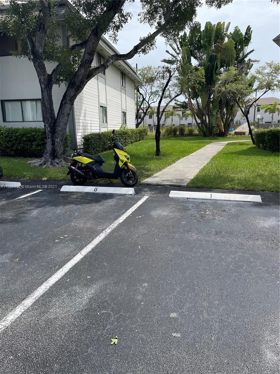 20681 Northeast 4th Place, Unit 101 Miami, FL 33179 - Photo 2 of 5 a car parked on the side of the road