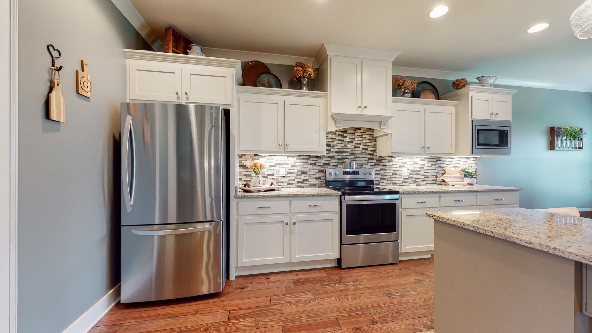 4017 Merryman Lane Murfreesboro, TN 37127 - Photo 17 of 62 a kitchen with granite countertop a refrigerator and a stove top oven